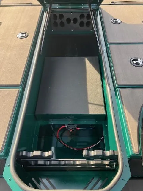 Slide: The Image of 2025 Lund 1875 Renegade SS boat interior storage compartment with green accents. - 17