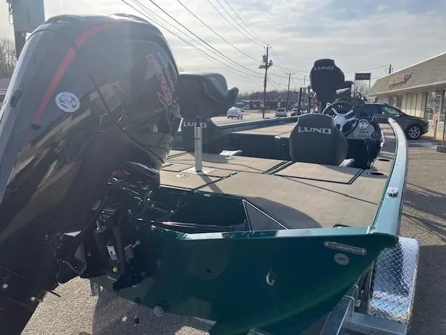Slide: The Image of 2025 Lund 1875 Renegade SS boat with powerful outboard motor, parked outdoors. - 4
