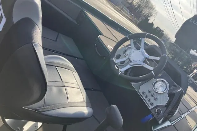 Slide: The Image of Interior of 2025 Lund 1875 Renegade SS boat with steering wheel and seat. - 6