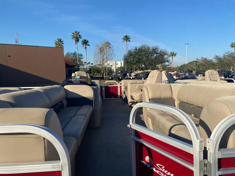 Slide: The Image of 2020 Sun Tracker Party Barge 24 DLX pontoon boat with beige seating, parked outdoors. - 3