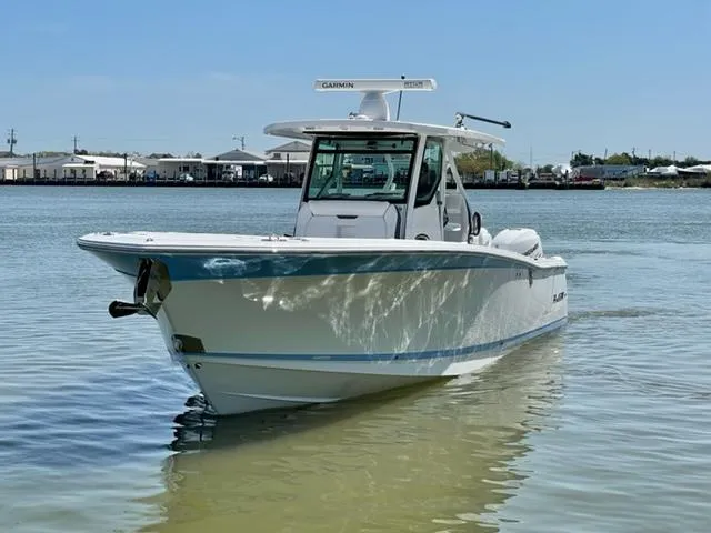 Slide: The Image of 2022 Blackfin 332 CC boat on calm water, showcasing sleek design and modern features. - 12