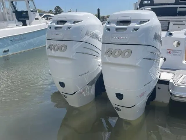 Slide: The Image of Twin Mercury 400 outboard engines on a 2022 Blackfin 332 CC boat in water. - 15