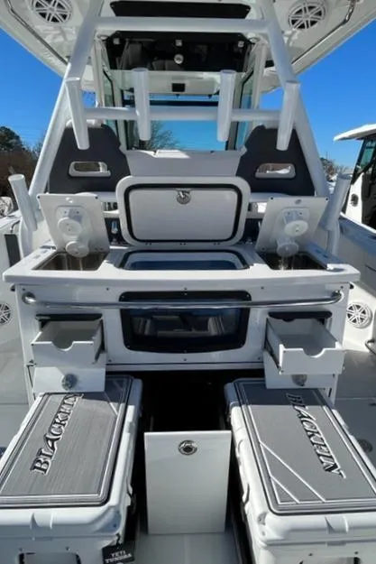 Slide: The Image of 2022 Blackfin 332 CC boat interior with storage compartments and seating. - 17