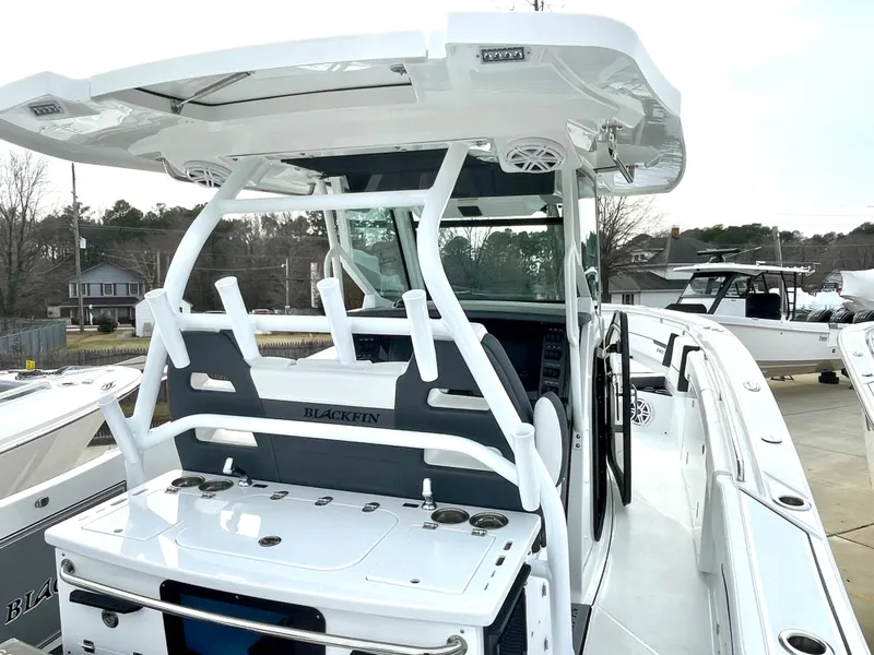 Slide: The Image of 2022 Blackfin 332 CC boat, featuring a sleek design and modern amenities, docked outdoors. - 18