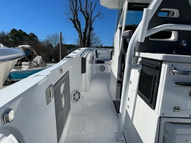 Slide: The Image of 2022 Blackfin 332 CC boat deck with seating and storage compartments. - 21