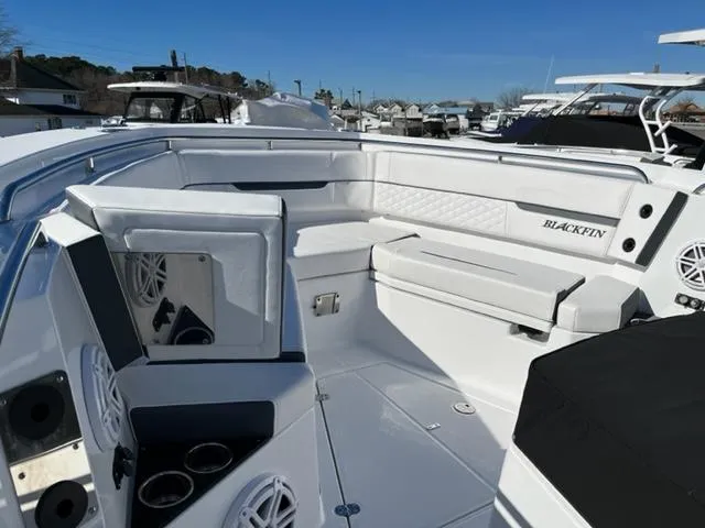 Slide: The Image of 2022 Blackfin 332 CC boat interior with white seating and cup holders. - 24