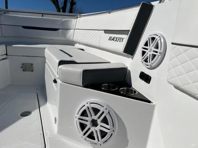 Slide: The Image of 2022 Blackfin 332 CC boat interior with speakers and cup holders. - 27