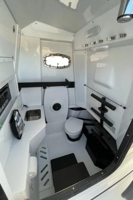 Slide: The Image of 2022 Blackfin 332 CC boat interior with compact bathroom and modern amenities. - 29
