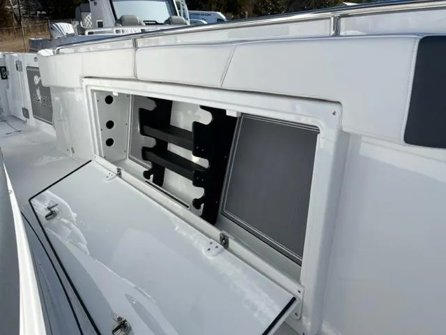 Slide: The Image of 2022 Blackfin 332 CC boat storage compartment with open hatch, showcasing sleek design. - 30