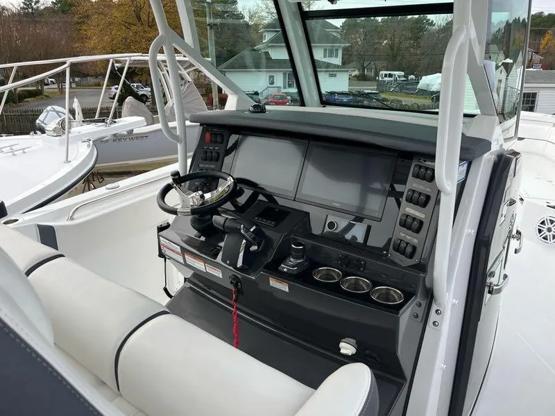 Slide: The Image of 2022 Blackfin 332 CC boat cockpit with modern controls and steering wheel. - 7