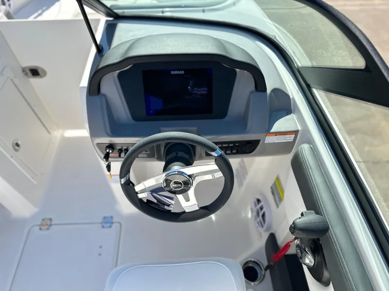 Slide: The Image of 2025 Chaparral 21 SSi Ski & Fish boat dashboard with steering wheel and digital display. - 5