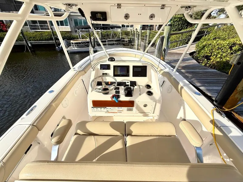 Slide: The Image of 2016 Pursuit S 280 Sport boat interior with helm, steering wheel, and seating. - 16