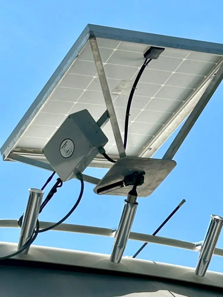 Slide: The Image of Solar panel mounted on a 2016 Pursuit S 280 Sport boat under a clear blue sky. - 29