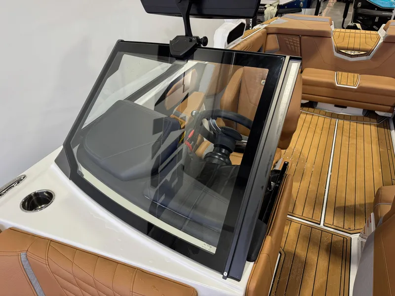 Slide: The Image of 2025 Nautique Super Air Nautique S23 interior with tan seating and sleek dashboard. - 20