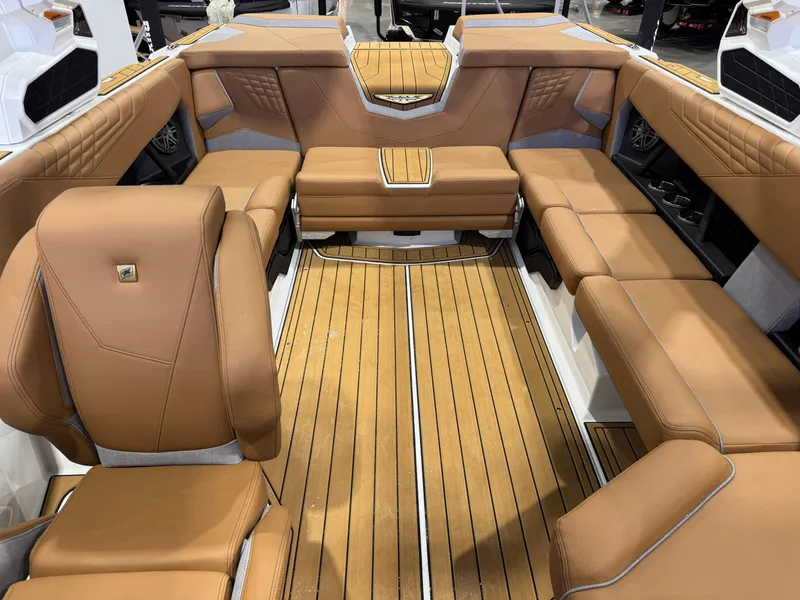 Slide: The Image of Luxurious interior of 2025 Nautique Super Air Nautique S23 with tan leather seating. - 22