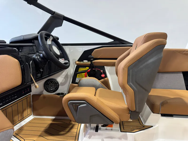 Slide: The Image of 2025 Nautique Super Air Nautique S23 interior with tan seats and modern dashboard. - 23
