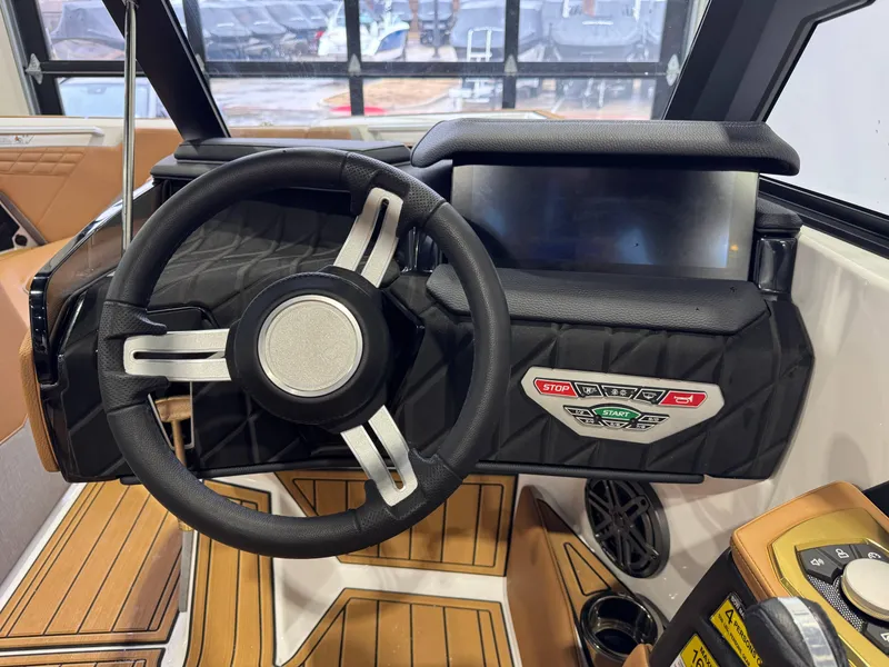 Slide: The Image of 2025 Nautique Super Air Nautique S23 steering wheel and dashboard interior. - 26