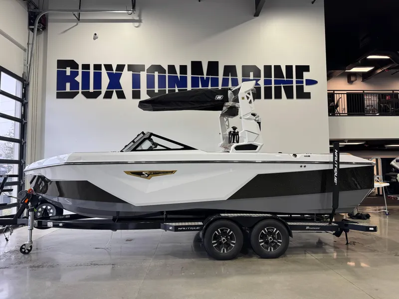 Slide: The Image of 2025 Nautique Super Air Nautique S23 boat displayed at Buxton Marine showroom. - 4