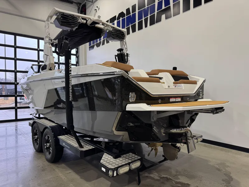 Slide: The Image of 2025 Nautique Super Air Nautique S23 boat on trailer in showroom. - 5