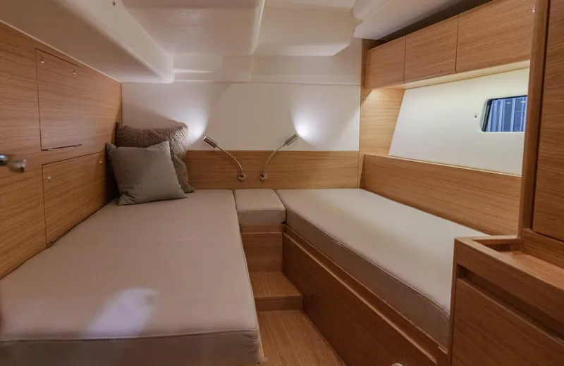 Slide: The Image of 2026 X-Yachts X4 9 interior cabin with wooden finish and twin beds. - 4