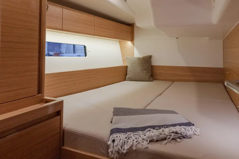 Slide: The Image of 2026 X-Yachts X4 9 interior cabin with cozy bed and window view. - 5