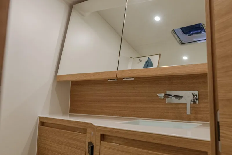 Slide: The Image of Modern bathroom interior of 2026 X-Yachts X4 9, featuring sleek wood cabinetry and mirror. - 6