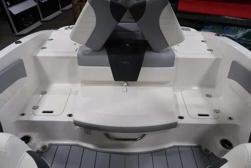 Slide: The Image of 2025 Chaparral 21 SSi boat interior with gray and white seating and storage compartments. - 12
