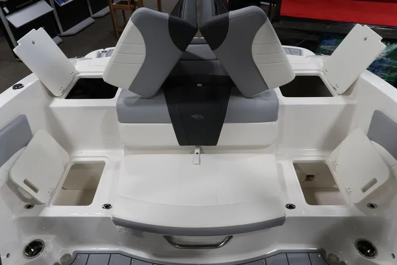 Slide: The Image of 2025 Chaparral 21 SSi boat interior with gray and white seating and storage compartments. - 15