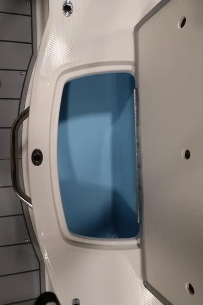 Slide: The Image of 2025 Chaparral 21 SSi boat storage compartment with blue interior. - 16