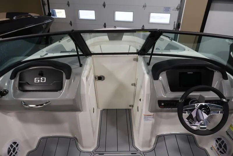 Slide: The Image of 2025 Chaparral 21 SSi boat interior with steering wheel and dashboard controls. - 20