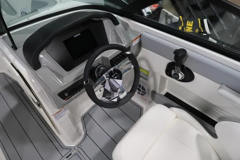 Slide: The Image of 2025 Chaparral 21 SSi boat cockpit with steering wheel and control panel. - 23