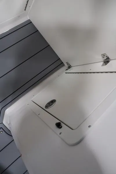 Slide: The Image of 2025 Chaparral 21 SSi boat interior with storage compartment and sleek design. - 28