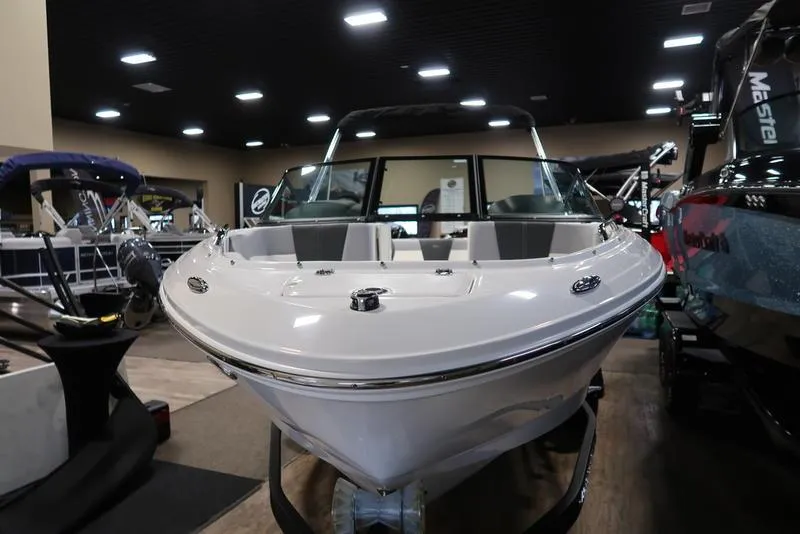 Slide: The Image of 2025 Chaparral 21 SSi boat displayed indoors, showcasing sleek design and modern features. - 7