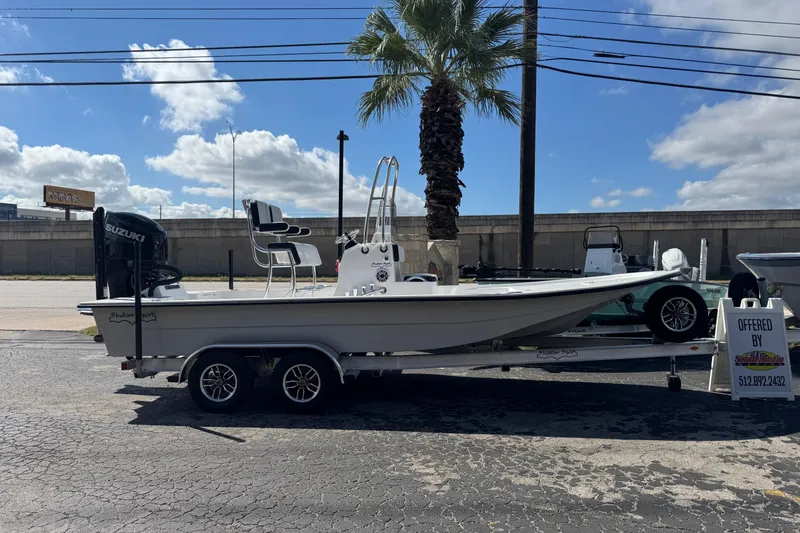 The Image of 2026 Shallow Sport 22 Sport boat on trailer, parked outdoors under a clear sky. - 0