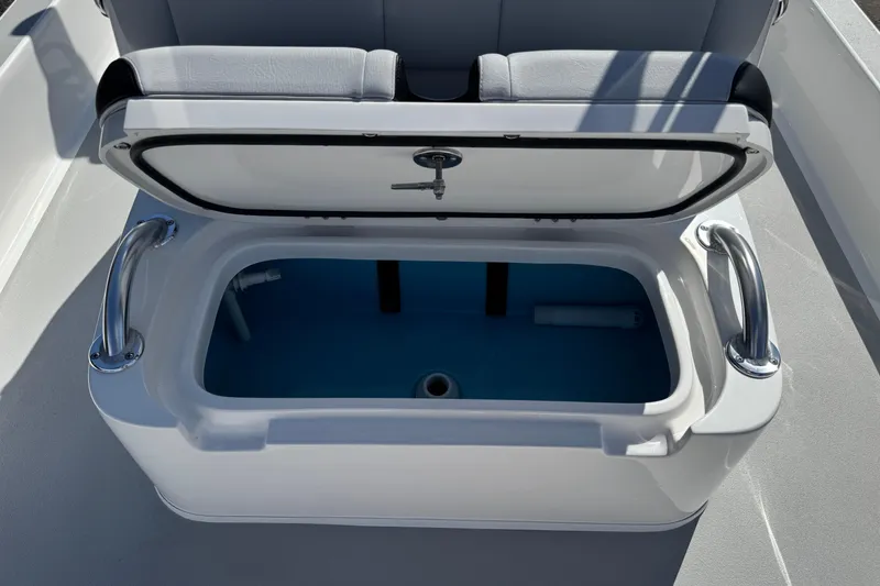 Slide: The Image of Open storage compartment on 2026 Shallow Sport 22 Sport boat, featuring sleek design and functionality. - 13