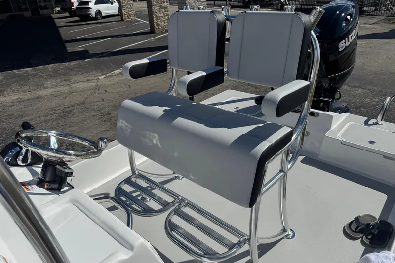 Slide: The Image of 2026 Shallow Sport 22 Sport boat interior with dual seating and steering wheel. - 15