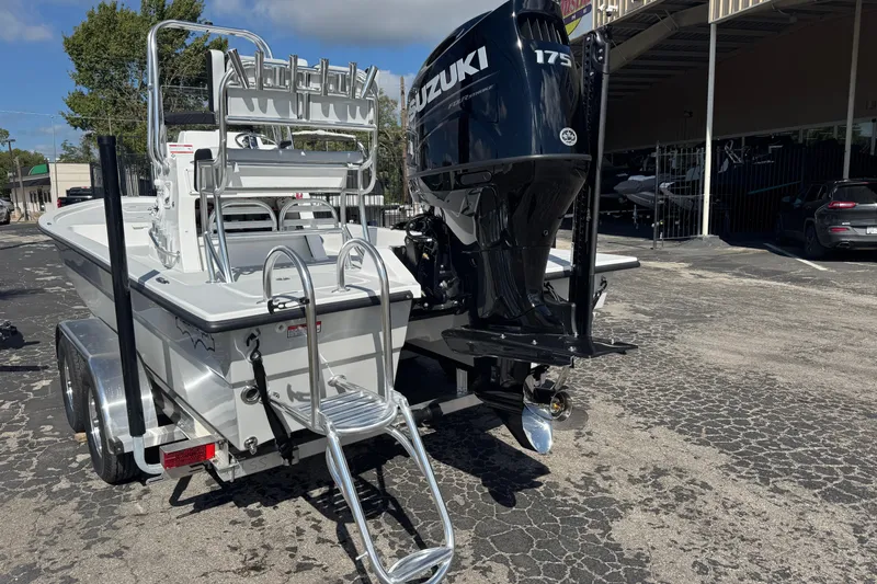 Slide: The Image of 2026 Shallow Sport 22 Sport boat with Suzuki 175 engine on trailer. - 2