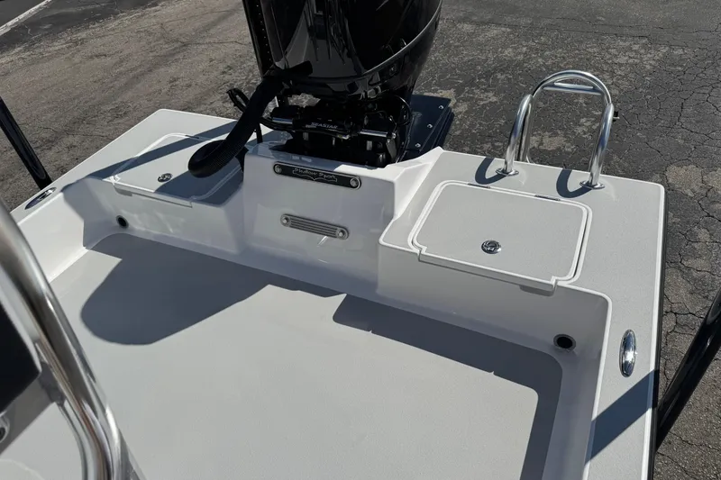 Slide: The Image of 2026 Shallow Sport 22 Sport boat deck with motor and storage compartments. - 22