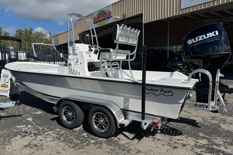 Slide: The Image of 2026 Shallow Sport 22 Sport boat on trailer, featuring Suzuki outboard motor. - 4