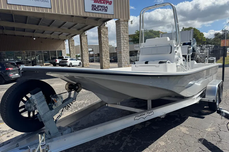 Slide: The Image of 2026 Shallow Sport 22 Sport boat on trailer outside dealership. - 5