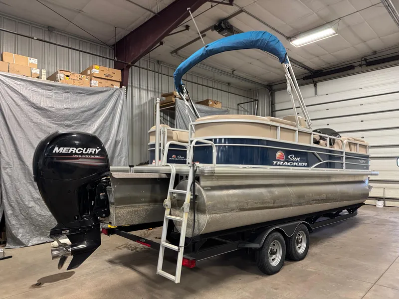 Slide: The Image of 2019 Sun Tracker Party Barge 22 XP3 pontoon boat with Mercury outboard in a garage. - 3