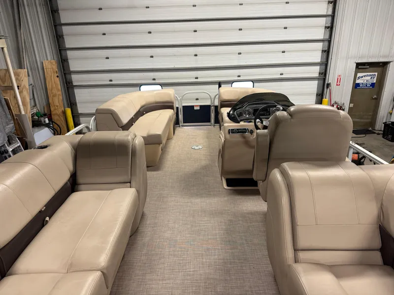 Slide: The Image of 2019 Sun Tracker Party Barge 22 XP3 interior with beige seating and steering console. - 5