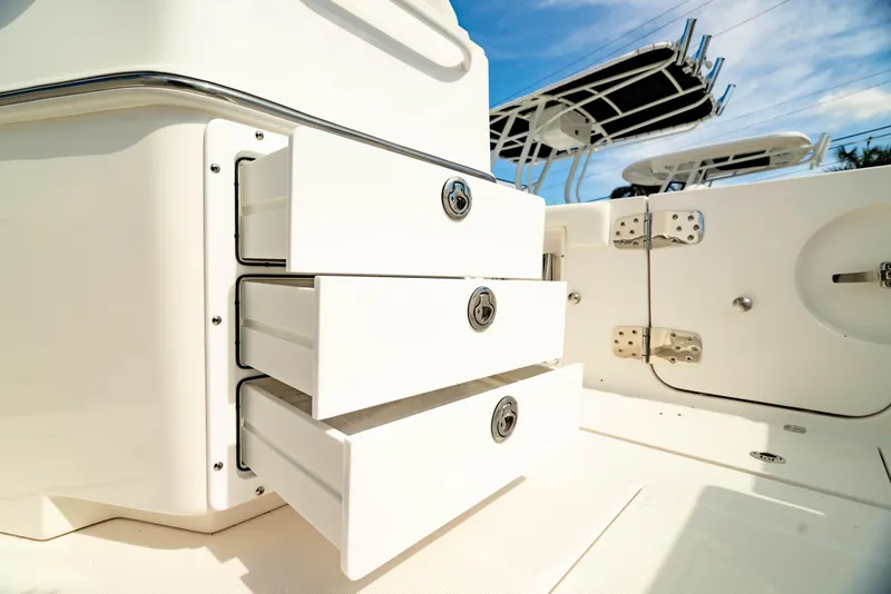 Slide: The Image of 2025 Edgewater 262CC boat interior with open storage drawers, showcasing sleek design and functionality. - 17
