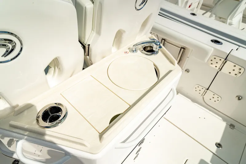 Slide: The Image of 2025 Edgewater 262CC boat interior with cup holders and storage compartments. - 20