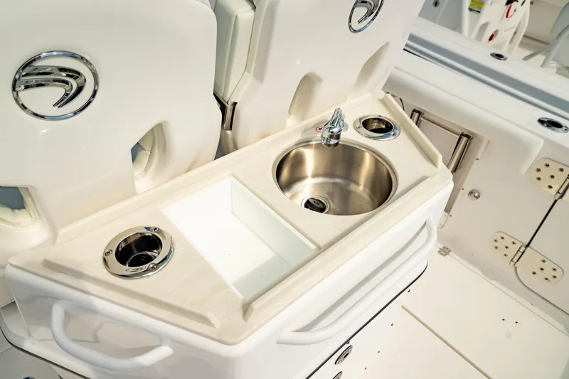 Slide: The Image of 2025 Edgewater 262CC boat interior with sink and storage compartments. - 21