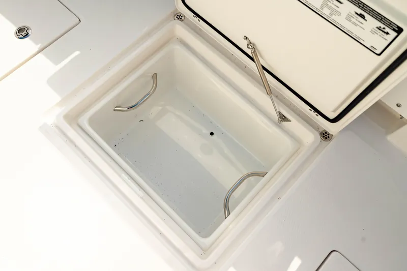 Slide: The Image of Open storage compartment on 2025 Edgewater 262CC boat. - 23