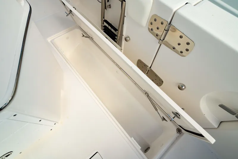 Slide: The Image of Open storage compartment on 2025 Edgewater 262CC boat, showcasing interior details. - 25