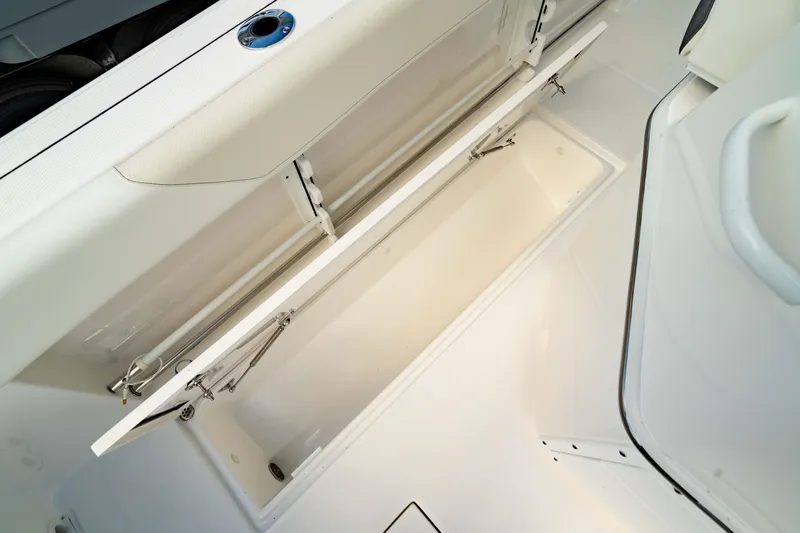 Slide: The Image of 2025 Edgewater 262CC boat storage compartment, open and empty, showcasing interior space. - 26