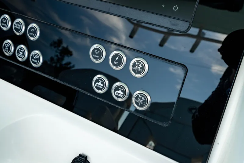 Slide: The Image of Control panel of 2025 Edgewater 262CC boat with various buttons and indicators. - 29