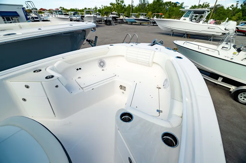 Slide: The Image of 2025 Edgewater 262CC boat interior, featuring spacious seating and modern design in a marina setting. - 3